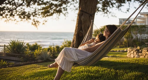 mother and daughter relaxing on hammock next to the ocean
